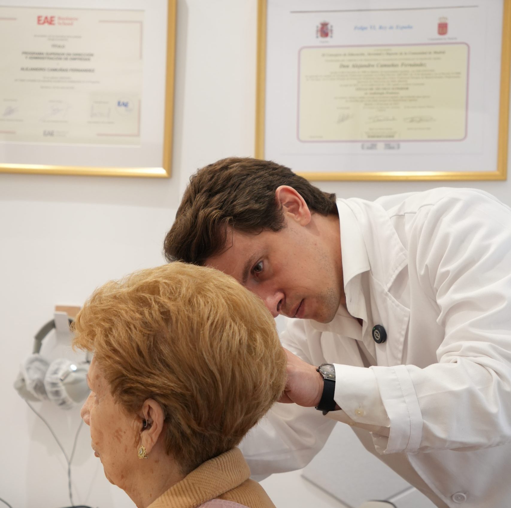 Alejandro Camuñas examinando el oído de una paciente en el centro auditivo Dr. Dears